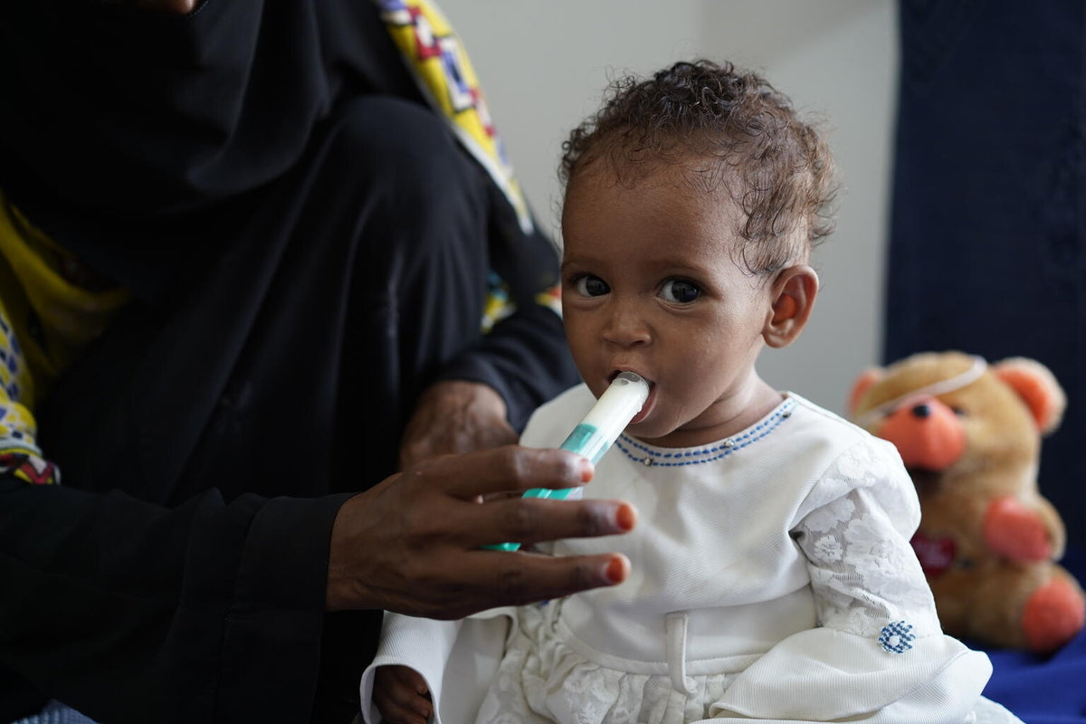 Baby receiving Therapeutic Milk Powder. © UNICEF/UN0671804/Hayyan