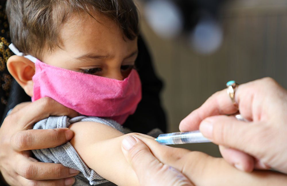 A young boy is immunised © UNICEF/UNI368583/Fazel