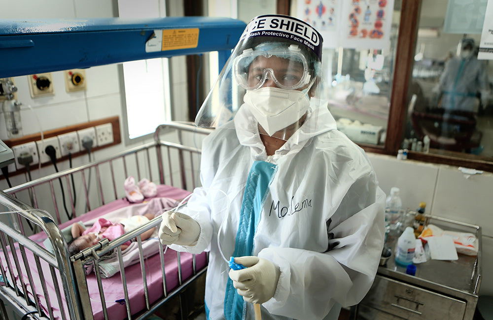 A health worker is pictured wearing Personal Protective Equipment (PPE) to help protect them from disease transmission. © UNICEF/UNI395227/Saeed